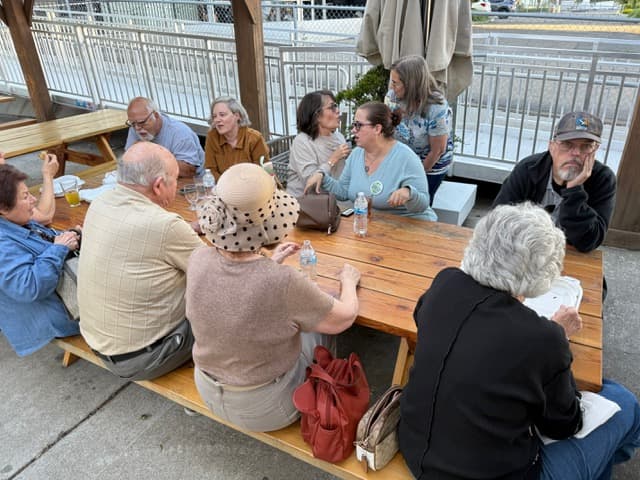 Neighbors connecting over conversation at a club fundraiser