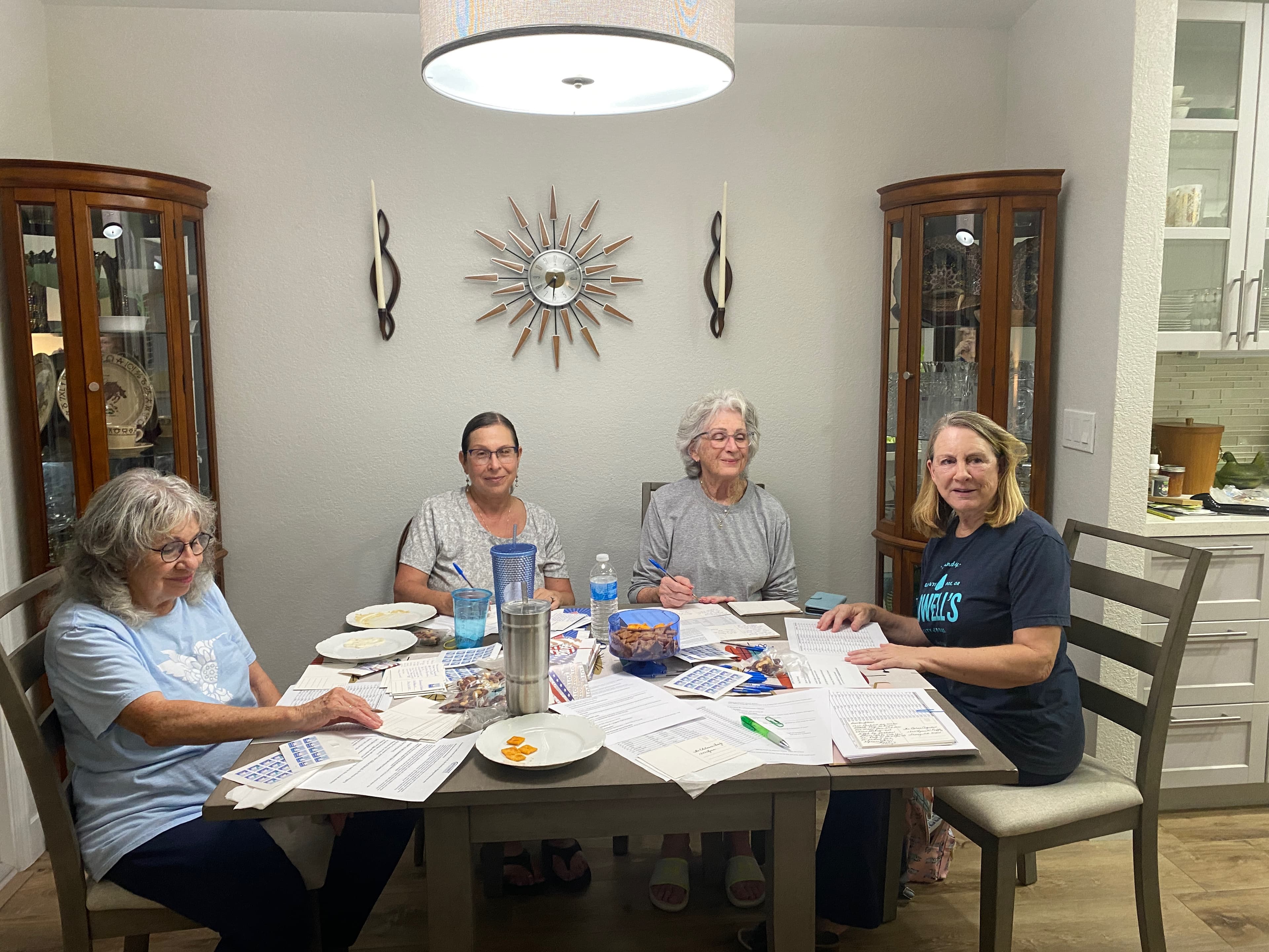 Volunteers writing postcards together at a Democratic Club of Greater Tracy outreach event